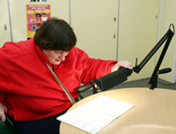 RNIB lady using an illuminated magnifier